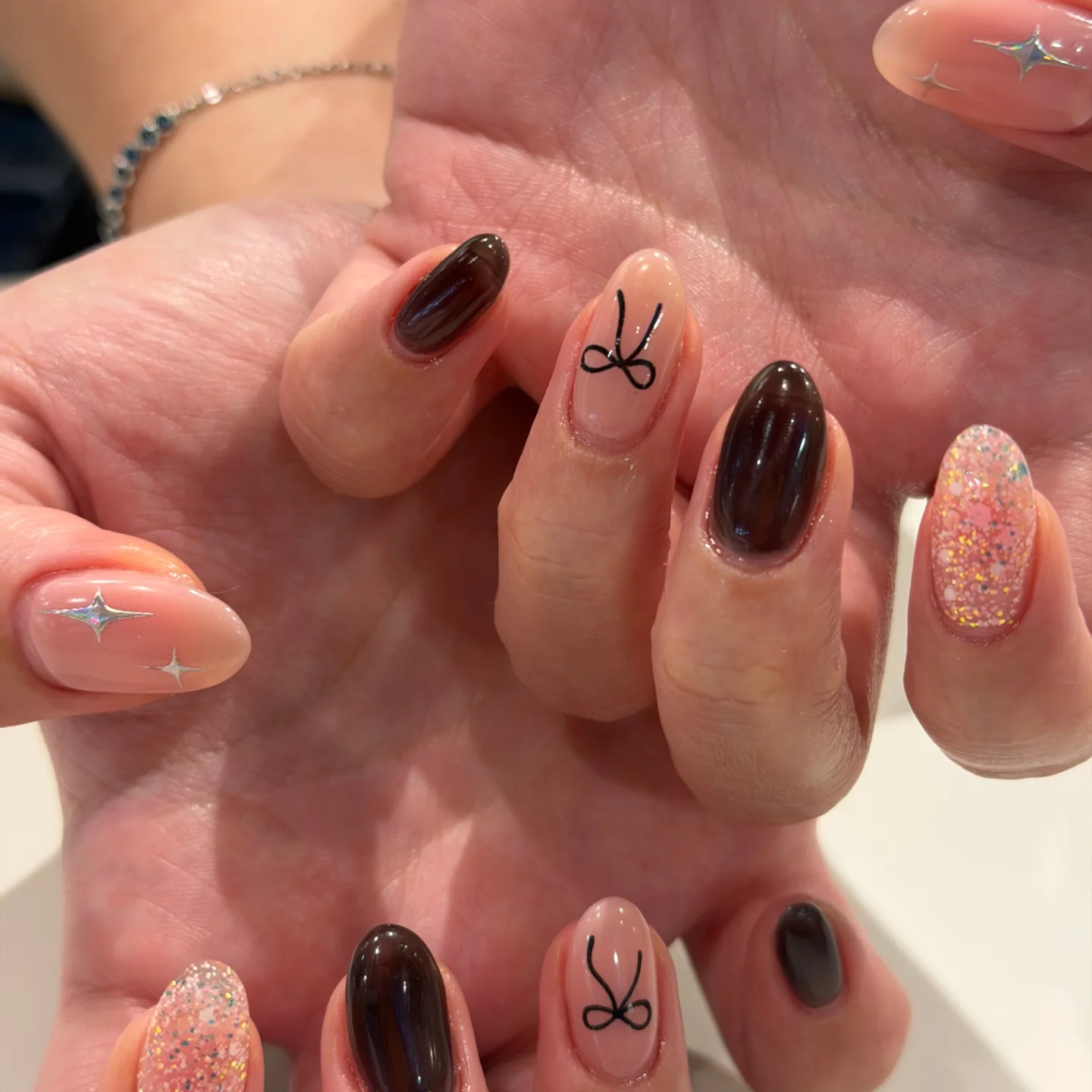 Glitter manicure with bow detail by Bella Beauty