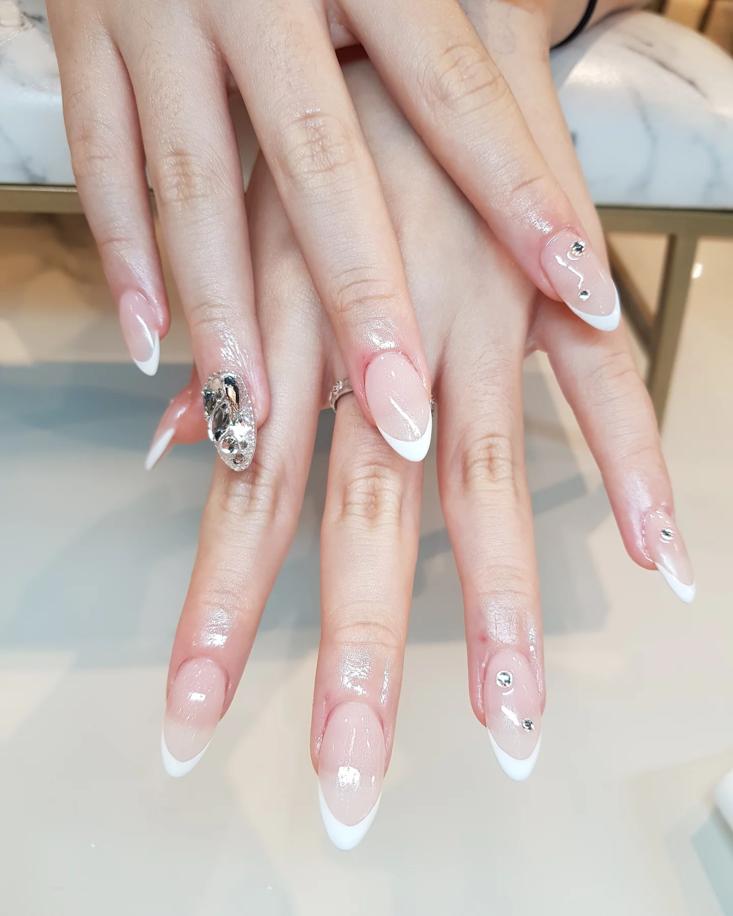 Pale pink French manicure with silver accent by Bella Beauty